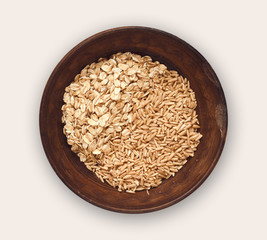 Bowl of oat flakes and grains isolated on white