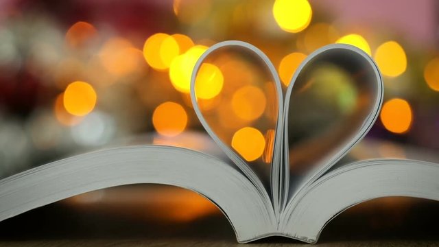 Book page decorate to heart shape with celebration bokeh light for love and a romance of valentines day concept