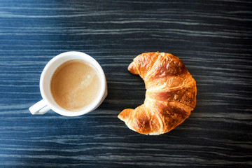 Breakfast with coffee and croissants on table