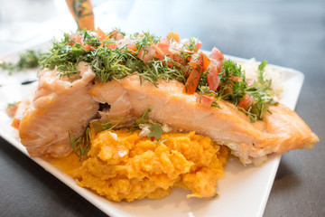 A seafood salad with smoked salmon, fresh lettuce, bread and lemon