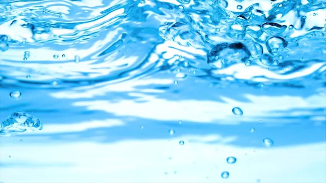 Ice cubes falling under water in slow motion