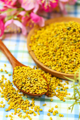 Bee pollen in wooden plate and spoon