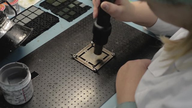 Manufacture of microchips. Step heating the solder paste with an industrial hair dryer
