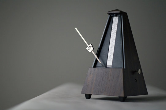 Monochromatic metronome in action isolated and on a plain background