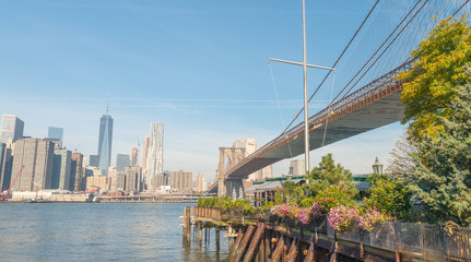 NEW YORK CITY - OCTOBER 25, 2015: Downtown Manhattan from Brooklyn Bridge Park. The city attracts...