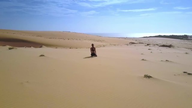 Woman Sits among Desert and Sky in Background Panorama