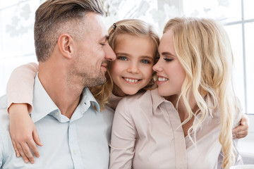 happy young family cuddling together