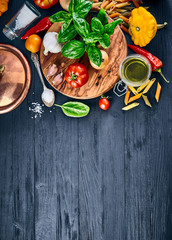 Italian food. Pasta basil tomato and olive oil on wooden black