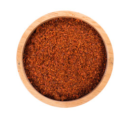 Pile of red paprika powder in bowl isolated background
