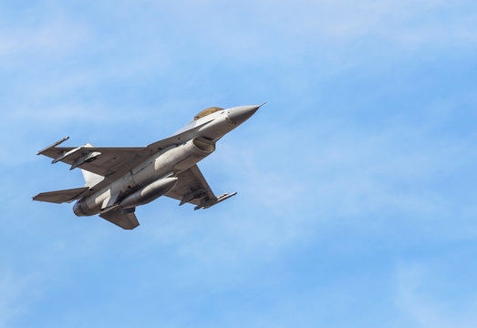 Falcon Fighter Jet Military Aircraft Flying On Blue Sky Background 