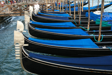 Fototapeta na wymiar Blue gondolas in Venice on the joke.