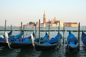 Fototapeta na wymiar Blue gondolas in Venice on the joke.
