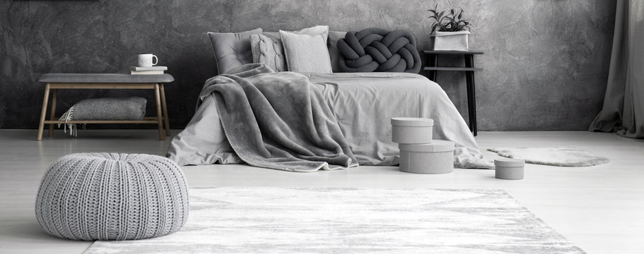 Grey pouf in bedroom interior