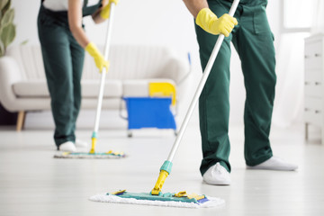 Cleaning team wiping the floor