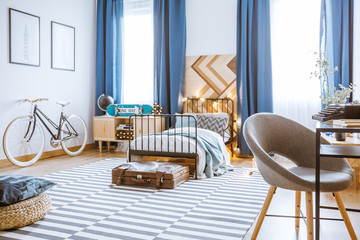 Grey armchair in bedroom interior