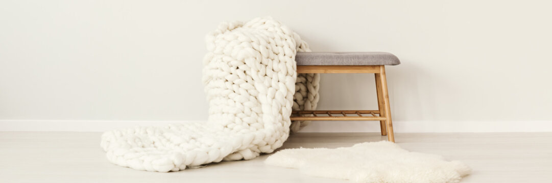 White Knit Blanket On Stool