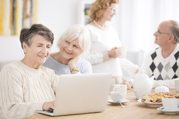 Elderly woman using laptop