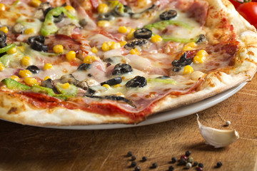 Italian Capriciosa pizza made with salami and vegetables