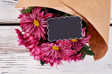 Greeting card and flowers on wooden background. Beautiful aster bouquet. Lovely compliment for...
