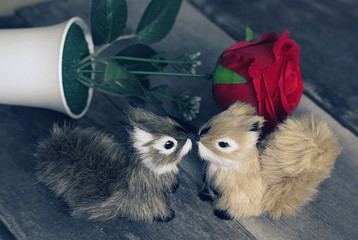  Vintage two squirrels kiss each other and red rose on background,love concept.