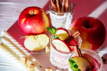 mulled wine in fishnet glasses on a light background, Apple, cinnamon, wine