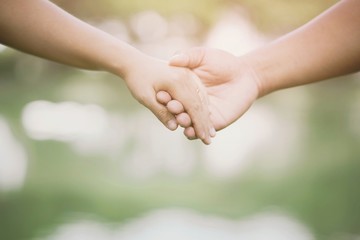Woman and man holding hands, Happy couple lover in the park.	