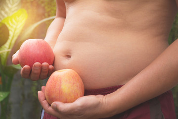 Fat belly man with apple. Fat belly man holding apple for healthy concept.