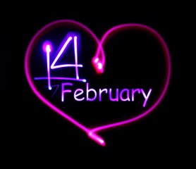 pink luminous neon heart with an inscription on February 14 in the middle