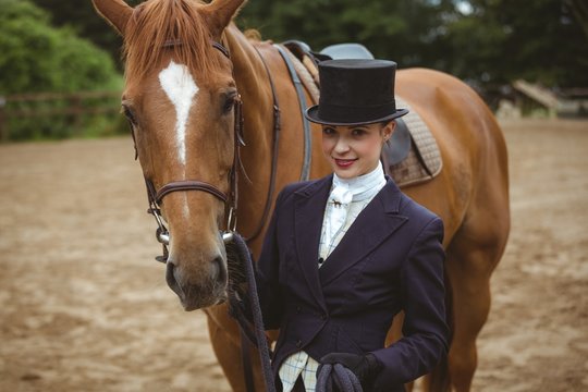 Female jockey leading her horse 