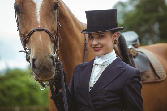 Female jockey leading her horse 