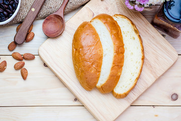 Sliced bread on wooden background.
