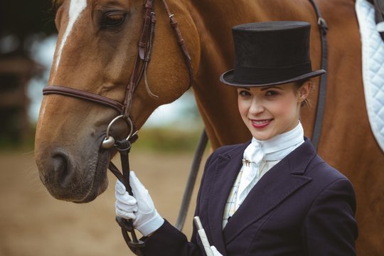 Female jockey leading her horse 