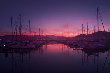 Marina with yachts and boats at beautiful sunset