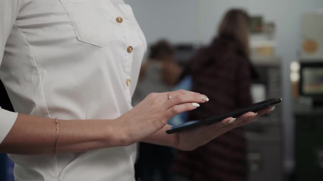 Businesswoman use digital tablet on ATM background, bank work, business woman withdrawal