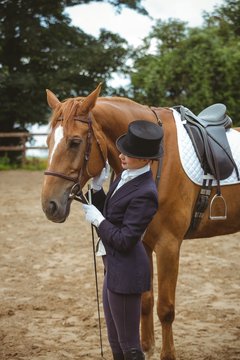 Female jockey leading her horse 