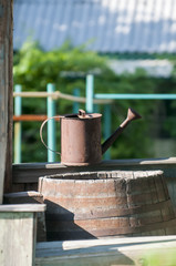 Wooden barrel and watering can