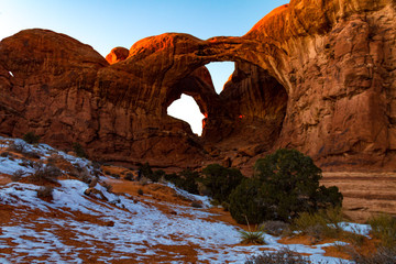 Gorgeous sunset shot of Double Arch at Arches National Park during the winter in Moab Utah USA.