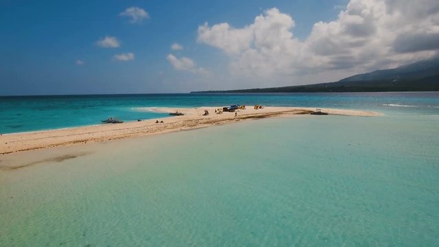 Aerial view of beautiful sand tropical island with white sand beach. White sand island. Beautiful sky, sea ,resort. Seascape: ocean and beautiful beach paradise. Philippines, Camiguin. 4K video