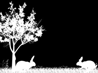 Obraz premium rabbit white silhouettes in grass near spring blossoming tree