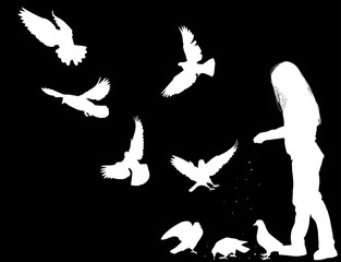 girl feeding doves isolated on black