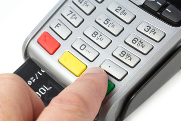 a person typing his credit card code on a payment terminal