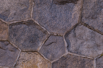 stone background granite texture. multifaceted dark cobblestone wall elements grunge background