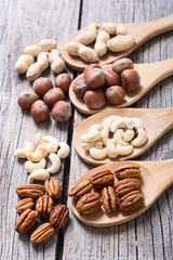 Mix of nuts in wooden spoon
