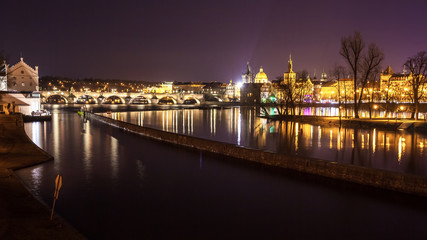 Charles Bridge and buildings along the Vltava at night, in Prague, Czech Republic
