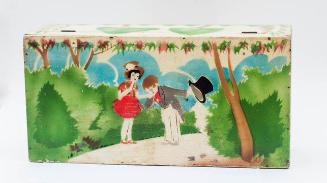 Retro box with painted scene: a little boy kisses a little girls hand