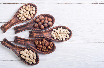 Mix of nuts in wooden spoon