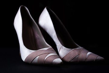 stylish Female pink shoes over black background