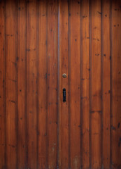 Wooden brown, aged doorway, latch and padlock.Backdrop, closeup, detail