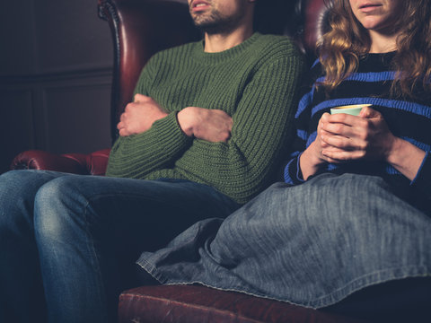 Cold young couple on sofa