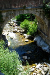 The River Tet runs by the pretty walled town of Villfranche de Conflent in the south of France....